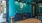 a clubhouse room with a green wall and blue cabinets