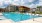 a swimming pool with a building in the background