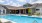 a swimming pool in front of a building