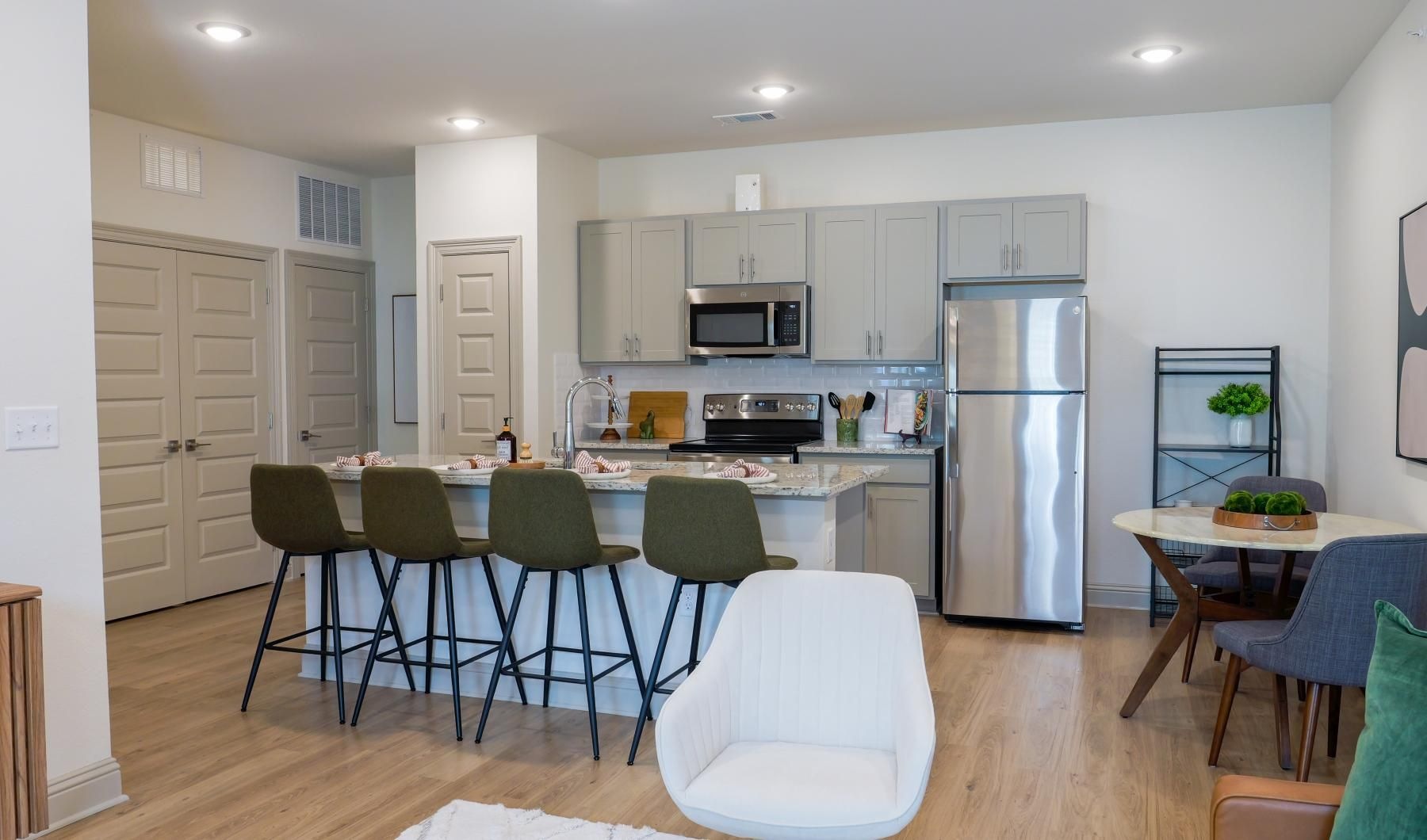 Beautiful kitchens with designer finishes a kitchen with a dining table and chairs