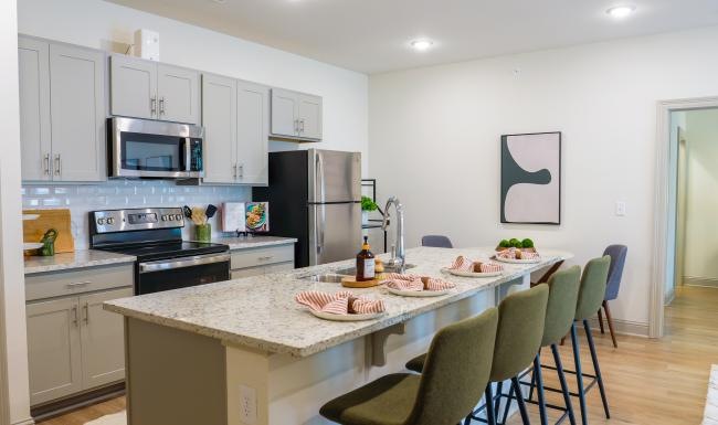 Beautiful kitchens with designer finishes a kitchen with an island and chairs
