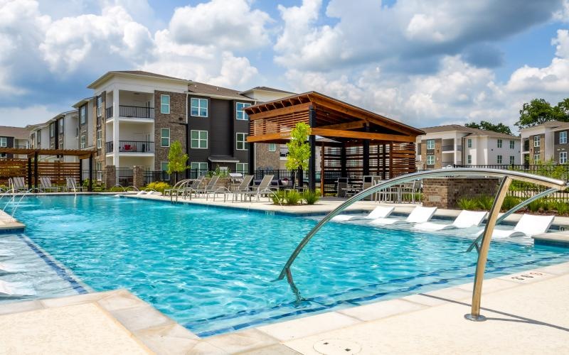 a swimming pool with a building in the background